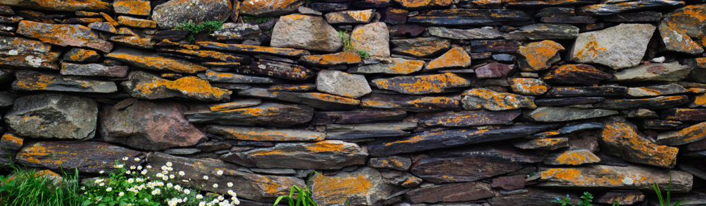 an up close image of a home's rock wall construction 