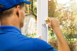 a contractor from R Company installing new glass