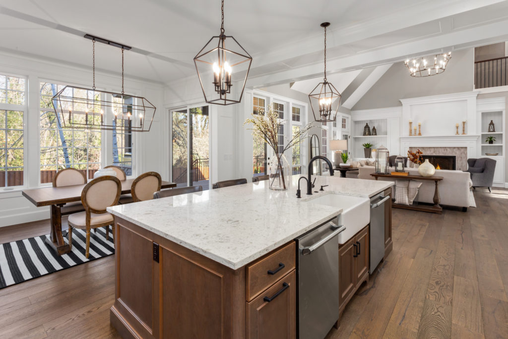 Beautiful kitchen in new traditional style luxury home, with quartz counters, hardwood floors, and stainless steel appliances